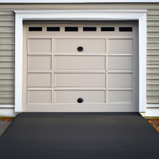 Suburban Acton home with a closed insulated garage door, weather seals and tracks visible in morning light.