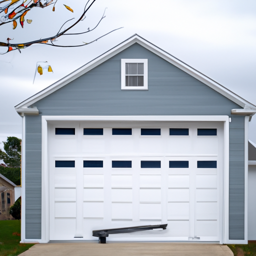 Sectional garage door on a Cape-style home in Acton, MA with tools on the driveway, no people.